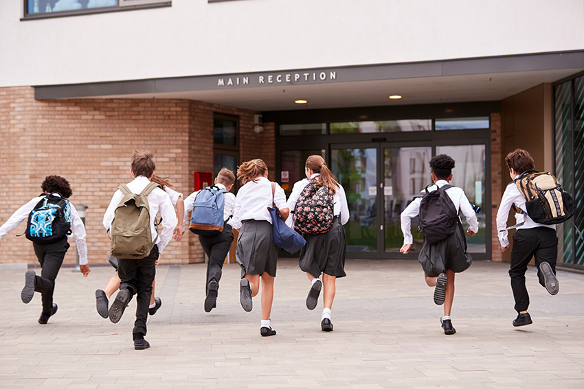 children running to school move from primary to secondary school